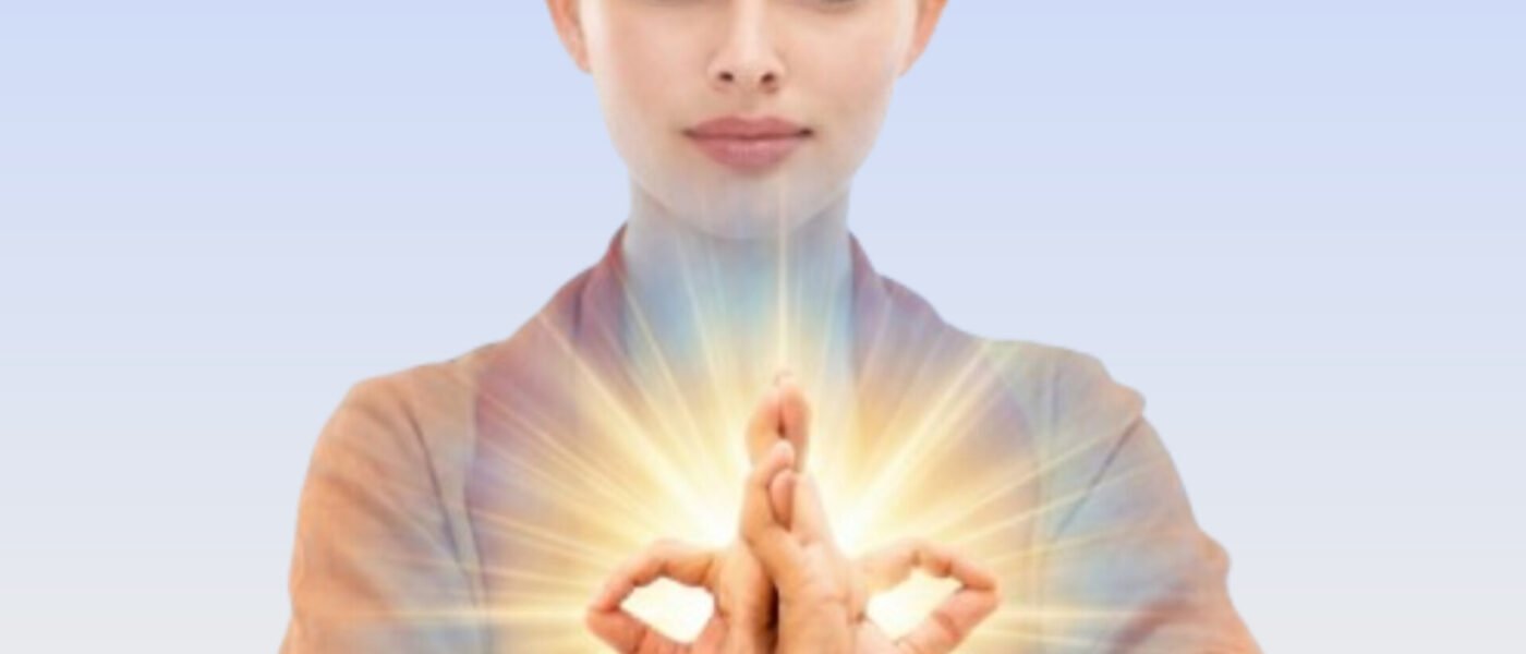 Acharya Sushma Kumari demonstrating Abhaya Hrdaya Mudra with crossed wrists and interlocked fingers for courage